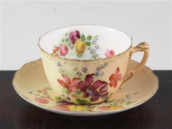 A Royal Worcester blush ground tea cup and saucer,